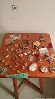Wide view of assorted jewelry laid out on wooden side table