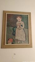 Full view of framed print showing a child holding a bird with beige matte and frame.