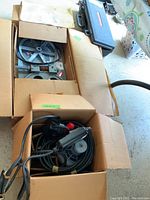 Two boxes, one with cables and motor components and the other with gear assemblies.