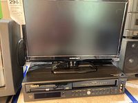 Front view showing black Element TV sitting on top of the Symphonic DVD/VHS player combo.