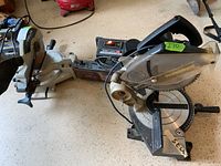 Overview of two miter saws (Delta Shopmaster on left, Black & Decker on right) and Craftsman sander visible in background