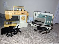 Both Singer sewing machines (Model 717 and Merritt 4530) shown side by side with their black foot pedals on a carpeted floor, showing overall condition and accessories.