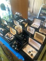 Wide view of countertop displaying sunglasses, cufflink boxes, keychain