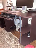 Front and side view of the computer desk showing desktop, keyboard tray, base, and under desk storage.