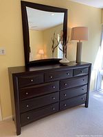 Full view of dresser and mirror with decorative items on top