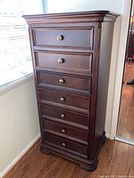 Seven drawer dark wood lingerie cabinet, side and front view showing full height and top surface.