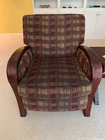 Front view of recliner chair showing patterned fabric upholstery and solid wood arms.