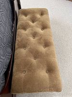 Top view of the brown tufted upholstered bedroom bench Ottoman showing the fabric texture and tufted button design.