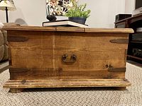 Front side showing drop handle, base moulding and distressed finish