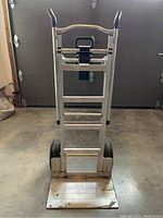 Front view of upright hand truck with loading platform folded up