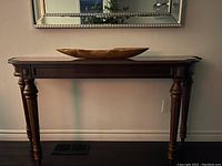 Front view showing full table length and carved apron