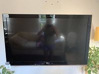 Frontal photo of the LG 42-inch TV powered off, showing reflective screen and black bezel with LG logo at bottom center.