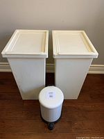Photo of 2 large white rectangular Ikea bins and 1 small white round pedal bathroom bin from front