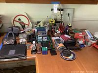 Overview of office supplies on desk including iPads, pens, staplers, tapes, and small electronics.