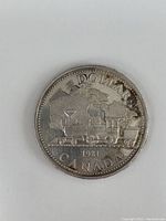 Close-up image of the reverse side of the 1981 Canadian silver dollar coin showing the locomotive and inscriptions.