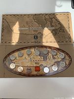 1999 Millennium Canada Coin Set displayed in open presentation case showing various coins against a map background