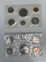 Photo showing two sealed sets of Canadian proof coins from 1971 and 1986, each containing six coins.