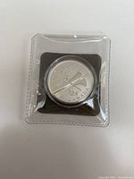 Image of a Canada 20 Dollar silver coin sealed in a clear plastic protective case, showing the beaver design and inscriptions.