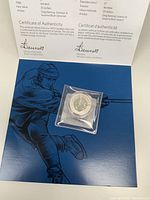 2013 Canada 20 Dollar silver coin in official display folder with Certificate of Authenticity featuring signatures and detailed information about the coin.