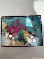 Image showing a set of 13 Canadian coins displayed on a map featuring provinces and descriptive text about Canada 125.