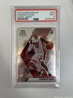 Front image of Kendrick Nunn 2019 Panini Mosaic basketball rookie card in white jersey, graded PSA 9 MINT, showing player in action with mosaic patterned background