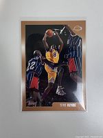 Front side of the 1998 Topps Kobe Bryant card showing action shot of Kobe Bryant in Lakers uniform with a gold border