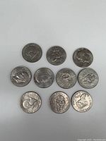 Top view of six USA silver quarters showing varied designs including Washington and Standing Liberty quarters.