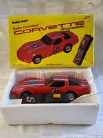 Photo of the car and controller in original white foam packaging inside box.