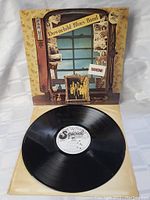 Vinyl LP record removed from sleeve showing black vinyl and white center label with Special Records logo.