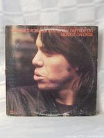 Front cover of George Thorogood and the Destroyers 'Move It On Over' LP showing profile photo of George Thorogood.