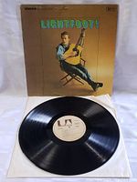 Vinyl LP record on white paper sleeve in front of the original album cover. Cover shows Gordon Lightfoot sitting with guitar.