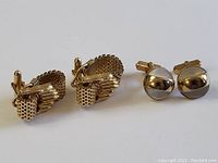 Pair of woven mesh design cuff links featuring gold-tone metal and intricate basket-weave pattern with toggle backs.