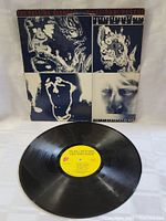 Vinyl LP record with yellow label showing the album title The Rolling Stones Emotional Rescue and track listing.