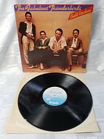 Vinyl record with visible Chrysalis label and album cover showing band members seated, front cover