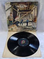Vinyl record and album cover showing band photo and title.