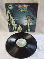 Vinyl LP record out of sleeve showing black vinyl with center label for Uriah Heep Demons and Wizards album, condition good to excellent.
