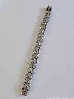 Full length view of vintage sterling silver heart link charm bracelet, showing clasp and overall condition