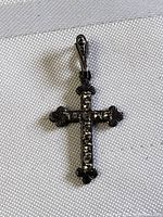 Front view of the vintage sterling silver cross pendant showing bead-encrusted details and fan-shaped ends of the arms