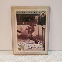Front side of Johnny Bower hockey card showing his autograph in blue ink and vintage player image.