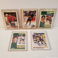 Front view of five hockey cards including Pavel Bure autographed rookie card and others in protective sleeves