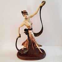 Front view of the full Art Deco female figure statue standing on wooden base.