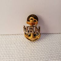 Front view showing detailed anchor with chain in gold plating and 'USN' letters in sterling silver with screw-back fastener.