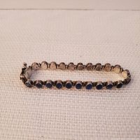 Full length view of bracelet showing oval lapis lazuli stones set in silver.
