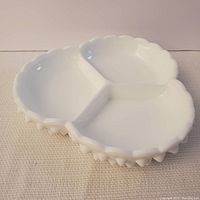 White hobnail milk glass sectioned serving dish showing three compartments from above.