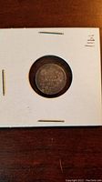 Reverse side of the 1911 Canadian 5 cent silver coin displaying denomination and year.