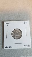 Front side of 1941 Newfoundland 10 cent coin showing denomination and date within circular border.