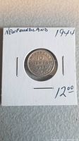 Front view of the 1944 Newfoundland 10 cent silver coin in white cardboard holder with handwritten year, region, and price.