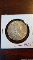 Front view of 1963 US Half Dollar coin showing Benjamin Franklin, date 1963, and inscriptions.