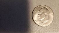 Obverse side of a 1971 Eisenhower silver clad one dollar coin showing Eisenhower's profile, inscriptions LIBERTY, IN GOD WE TRUST, 1971 date.