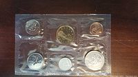 Six Canadian coins sealed in plastic showing front designs including various denominations with maple leaf and other Canadian emblems.